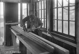 Carpenter in workshop at E.Z. Co. Zinc Works