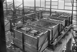 Interior tanks being fitted out in partially constructed building at E.Z. Co. Zinc Works