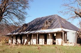Front view of abandoned shingle-roofed dwelling on Montacute property