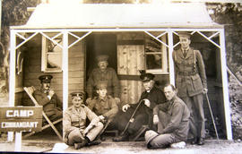 Men on verandah of Camp Commandant Cottage