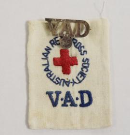 Fabric  Australian Red Cross Society VAD badge with metal VAD badge  attached