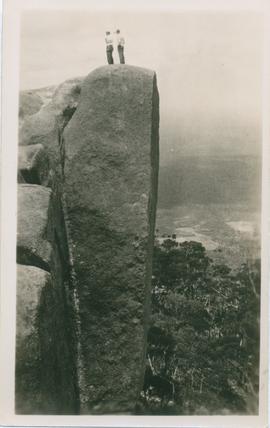 Photograph of two people on rock