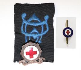 Metal Red Cross badges  – one with navy embroidered badge attached