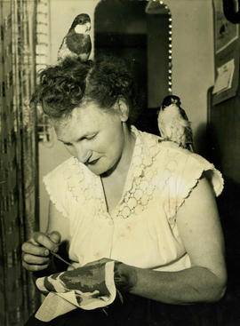 Marjorie with her pet birds and her needlework